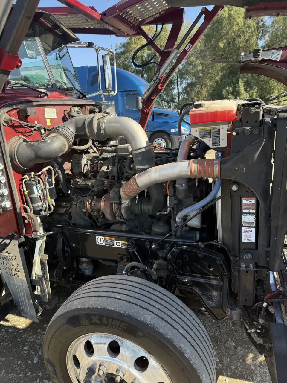 Open heavy duty truck engine bay showing cooling and intake components